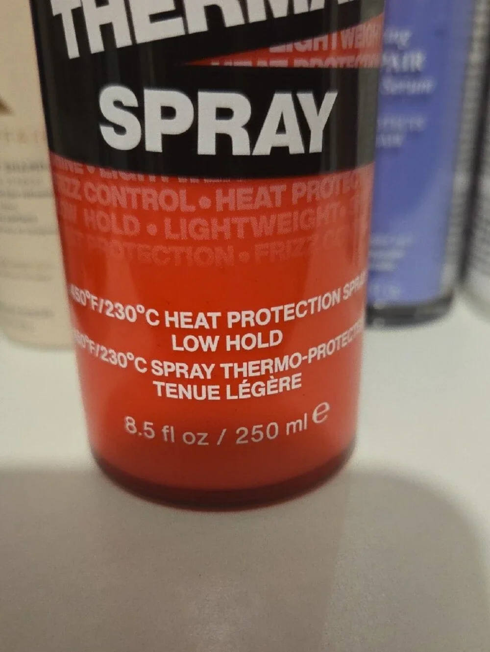 Redken Thermal Spray 11 in Bright Red and Black Bottle